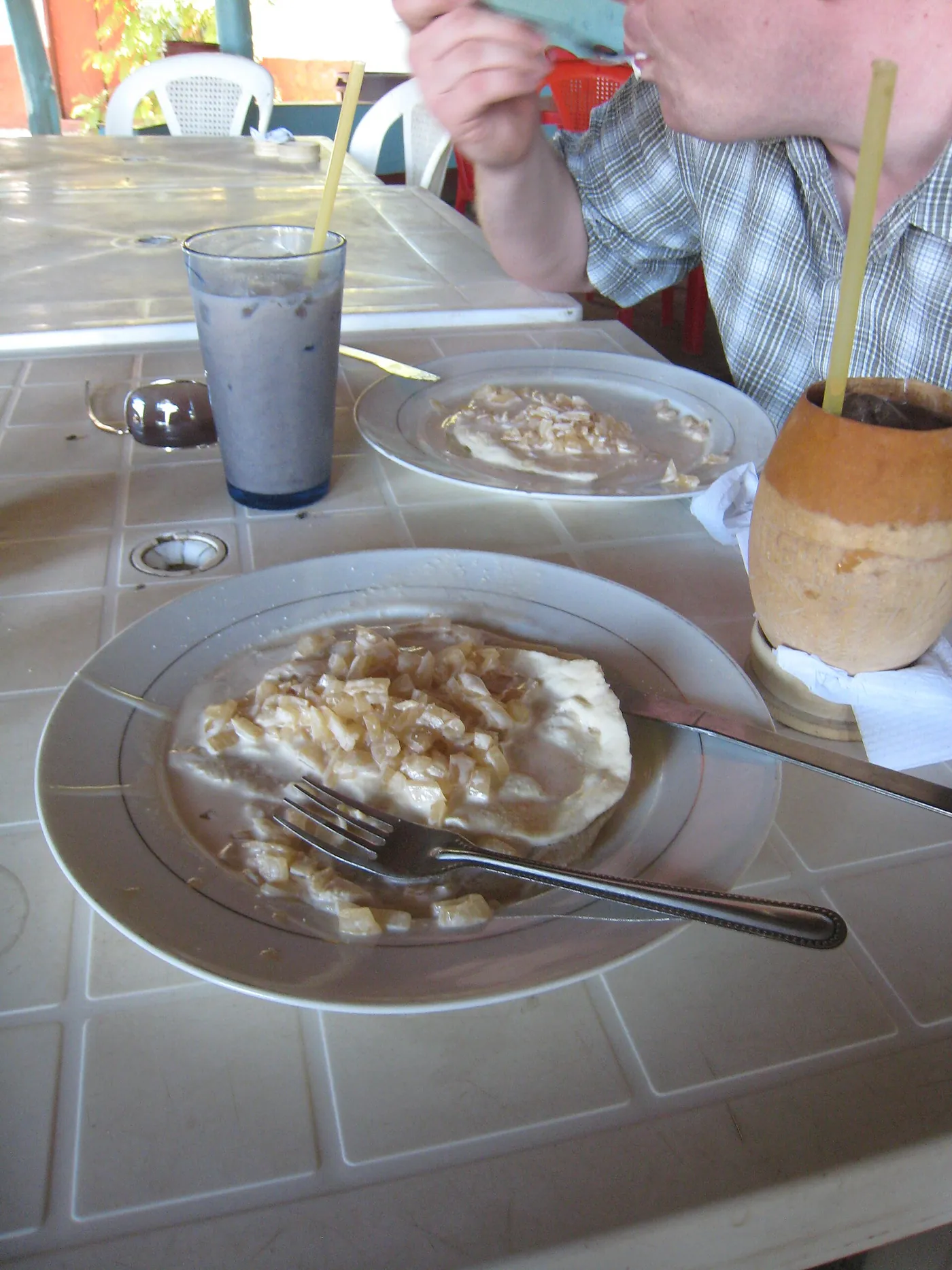 A quesillo, a tortilla wrapped around soft cheese with onion and cream